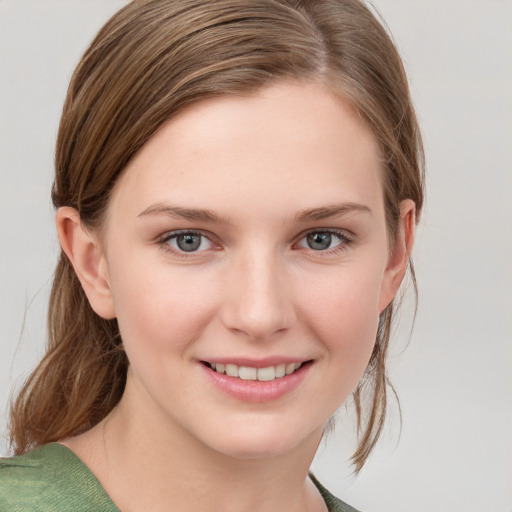 Joyful white young-adult female with medium  brown hair and grey eyes