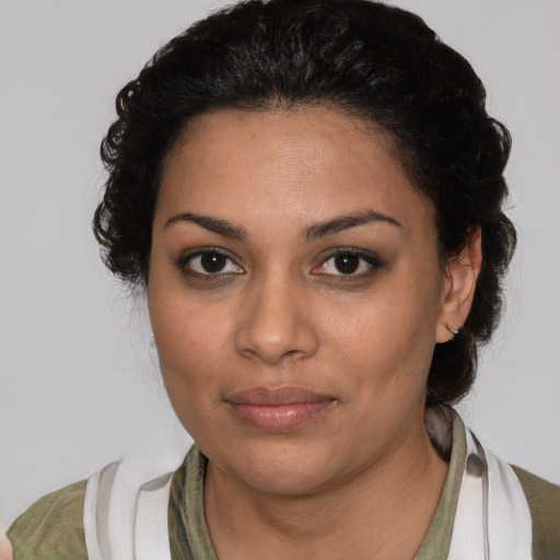 Joyful latino young-adult female with medium  brown hair and brown eyes