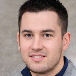 Joyful white young-adult male with short  brown hair and brown eyes