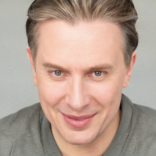 Joyful white adult male with short  brown hair and grey eyes