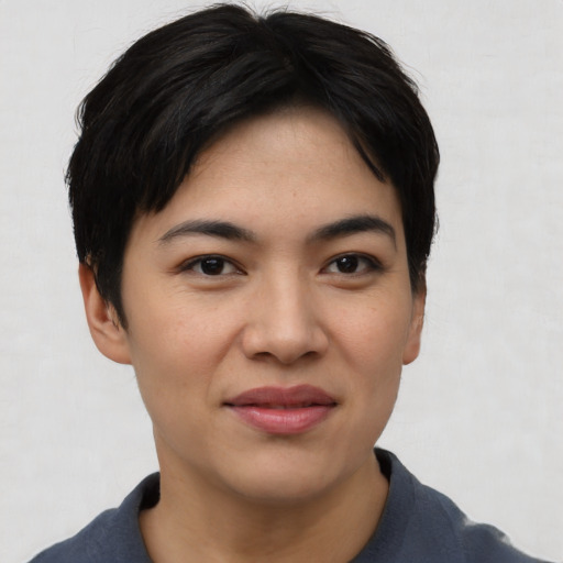Joyful asian young-adult female with short  black hair and brown eyes