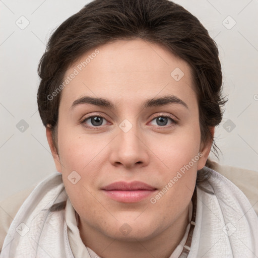 Joyful white young-adult female with short  brown hair and grey eyes