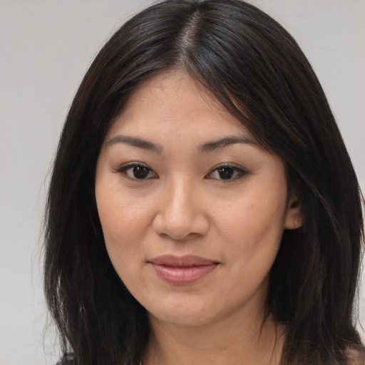 Joyful asian young-adult female with long  brown hair and brown eyes