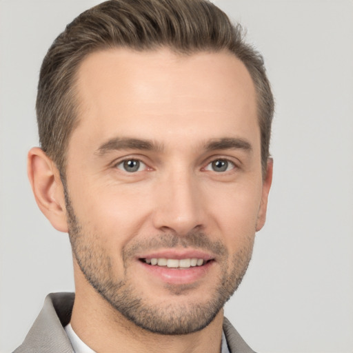 Joyful white young-adult male with short  brown hair and brown eyes