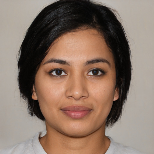 Joyful latino young-adult female with medium  black hair and brown eyes