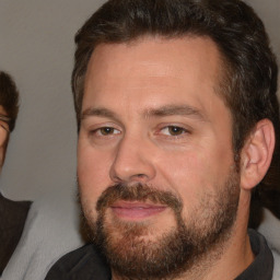 Joyful white adult male with short  brown hair and brown eyes