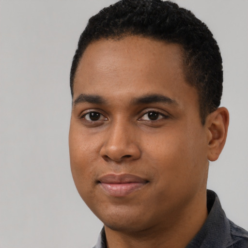 Joyful black young-adult male with short  black hair and brown eyes