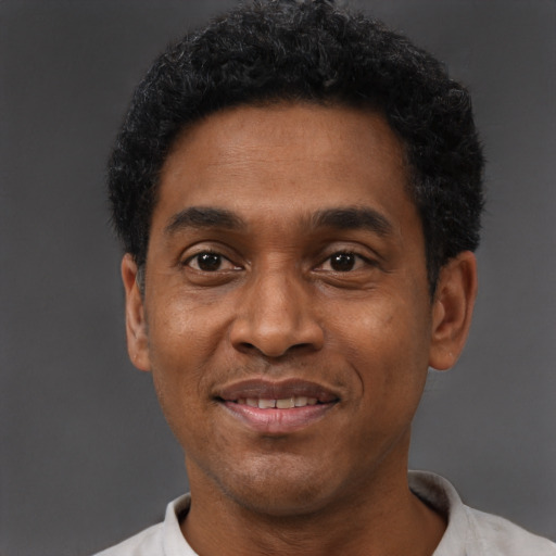 Joyful latino adult male with short  black hair and brown eyes