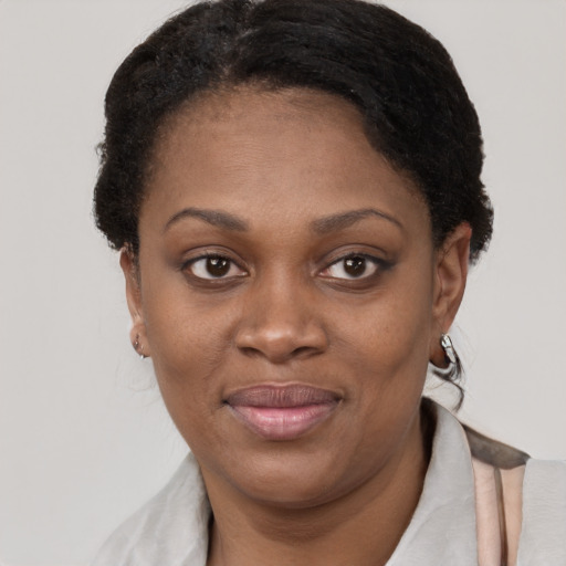 Joyful black young-adult female with short  brown hair and brown eyes