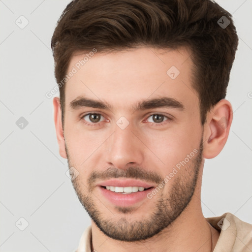 Joyful white young-adult male with short  brown hair and brown eyes