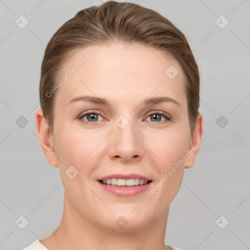 Joyful white young-adult female with short  brown hair and grey eyes