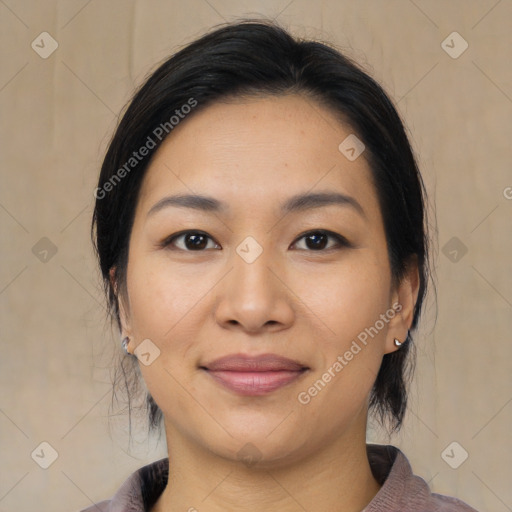 Joyful asian young-adult female with medium  black hair and brown eyes