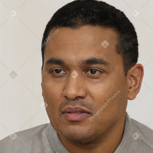 Neutral latino young-adult male with short  black hair and brown eyes