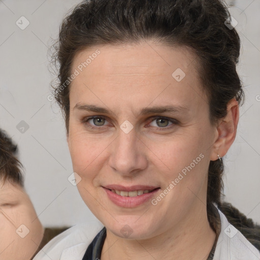 Joyful white adult female with medium  brown hair and brown eyes