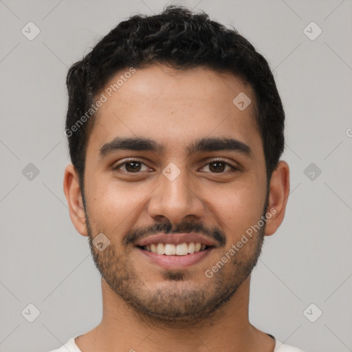 Joyful latino young-adult male with short  brown hair and brown eyes