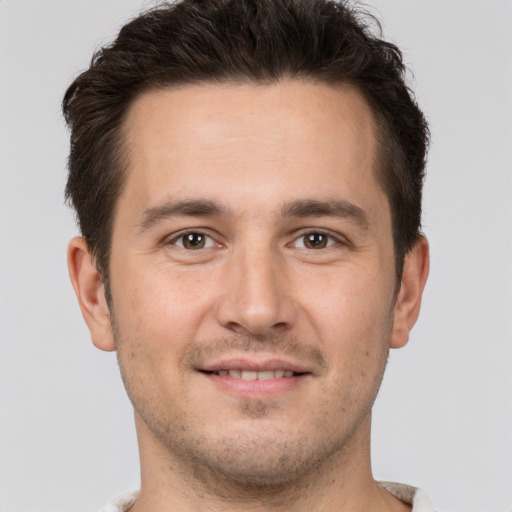 Joyful white young-adult male with short  brown hair and brown eyes