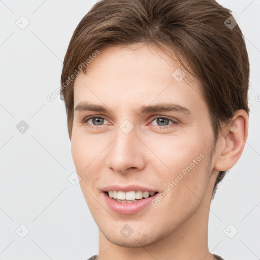 Joyful white young-adult female with short  brown hair and grey eyes