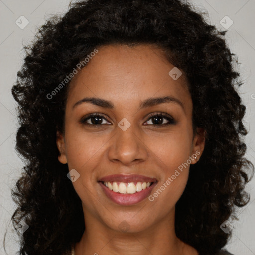 Joyful black young-adult female with long  brown hair and brown eyes