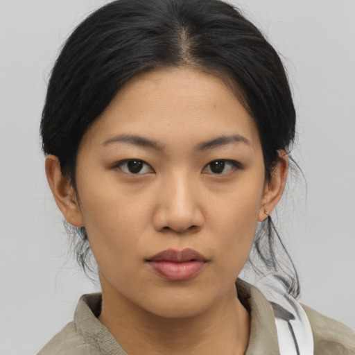 Neutral asian young-adult female with medium  brown hair and brown eyes