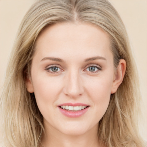 Joyful white young-adult female with long  brown hair and blue eyes