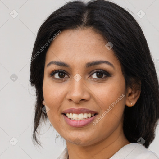 Joyful latino young-adult female with medium  brown hair and brown eyes