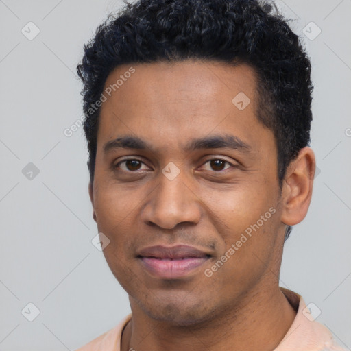 Joyful black young-adult male with short  black hair and brown eyes