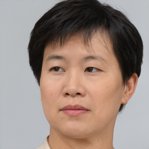 Joyful asian adult male with short  brown hair and brown eyes
