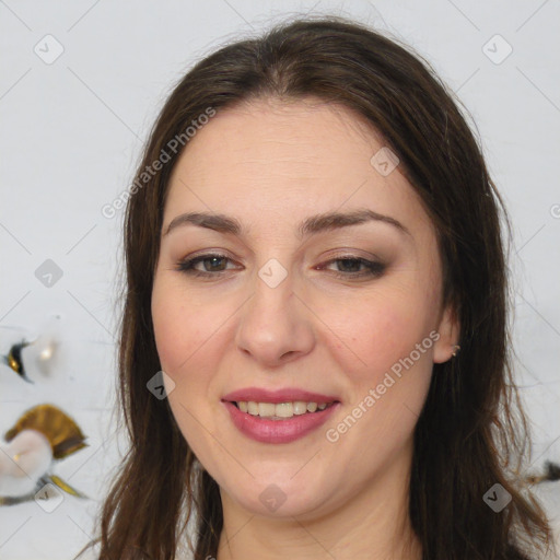 Joyful white adult female with long  brown hair and brown eyes