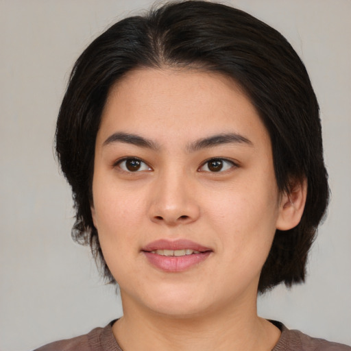 Joyful asian young-adult female with medium  brown hair and brown eyes