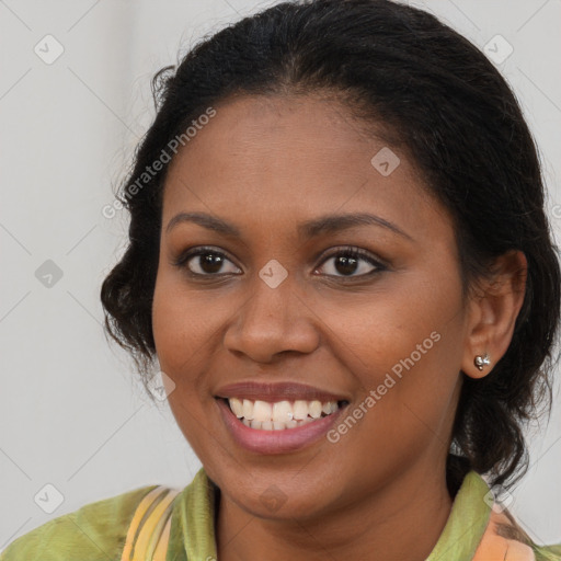 Joyful black young-adult female with long  brown hair and brown eyes