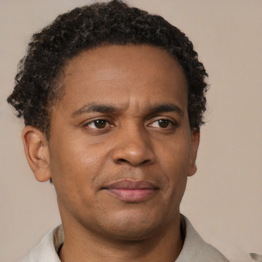 Neutral black adult male with short  brown hair and brown eyes