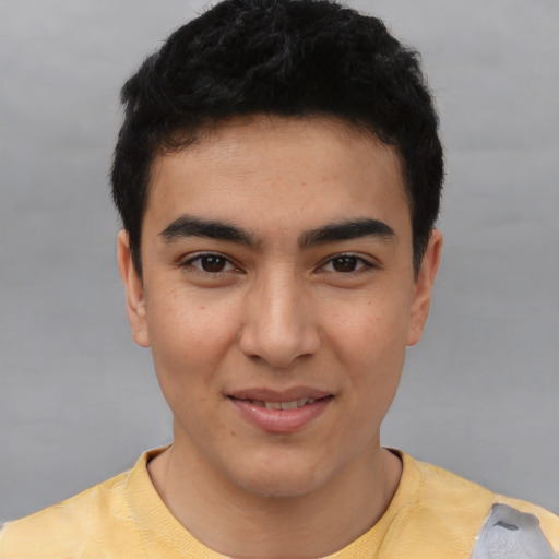 Joyful asian young-adult male with short  black hair and brown eyes