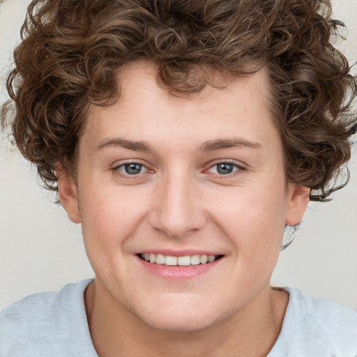 Joyful white young-adult male with short  brown hair and blue eyes