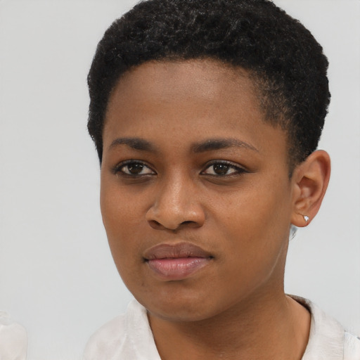 Joyful black young-adult female with short  black hair and brown eyes