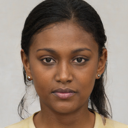 Neutral black young-adult female with medium  brown hair and brown eyes