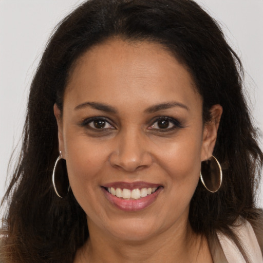 Joyful latino young-adult female with long  brown hair and brown eyes