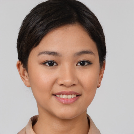 Joyful asian young-adult female with short  brown hair and brown eyes