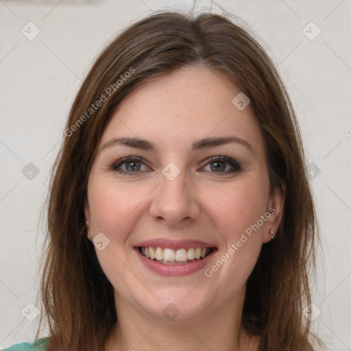 Joyful white young-adult female with long  brown hair and green eyes