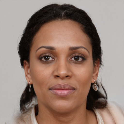 Joyful latino adult female with medium  brown hair and brown eyes