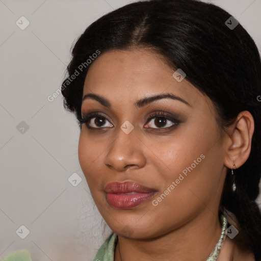 Joyful black young-adult female with long  brown hair and brown eyes