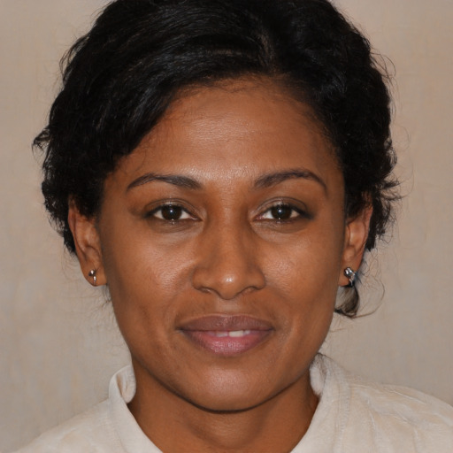 Joyful black young-adult female with medium  brown hair and brown eyes