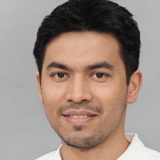 Joyful asian young-adult male with short  black hair and brown eyes