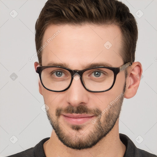 Joyful white young-adult male with short  brown hair and grey eyes