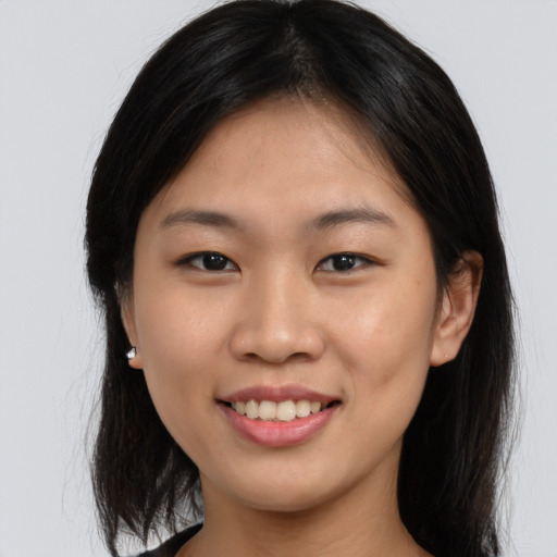 Joyful asian young-adult female with long  brown hair and brown eyes