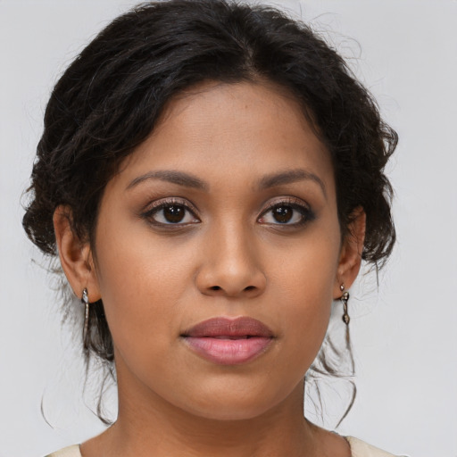 Joyful latino young-adult female with medium  brown hair and brown eyes
