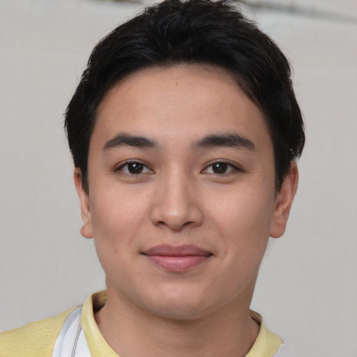 Joyful asian young-adult male with short  black hair and brown eyes