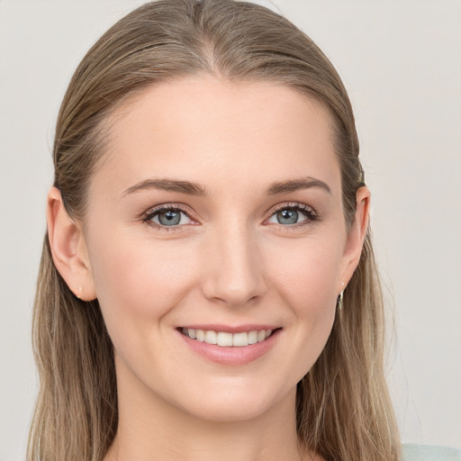 Joyful white young-adult female with long  brown hair and blue eyes