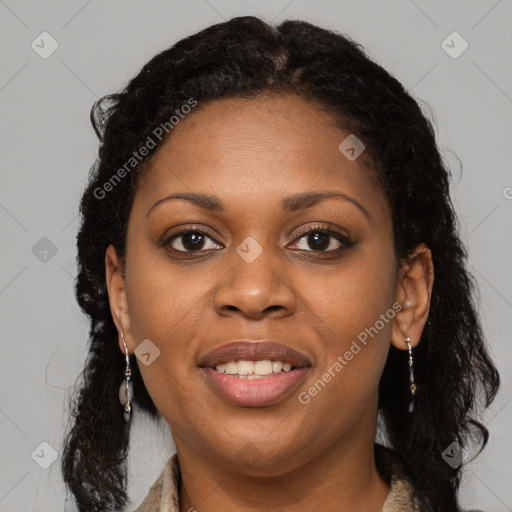 Joyful black young-adult female with long  brown hair and brown eyes