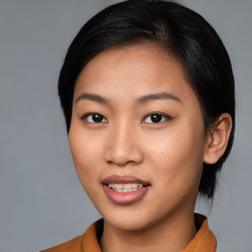 Joyful asian young-adult female with medium  brown hair and brown eyes