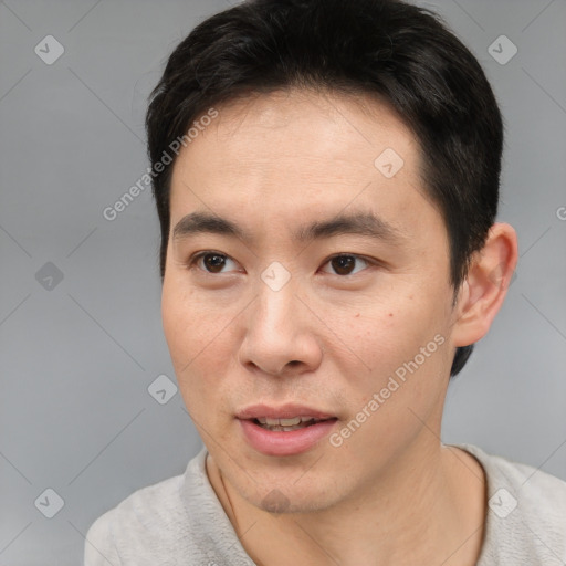 Joyful white young-adult male with short  black hair and brown eyes